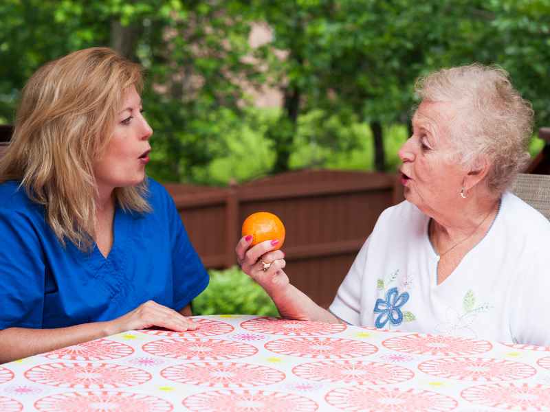 A stroke patient with dementia is undergoing speech therapy to improve their communication.